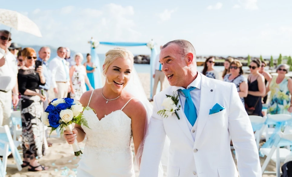 a man and woman walking down the beach