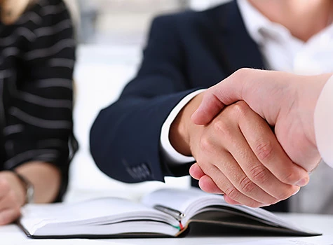 men shaking hands over a planner