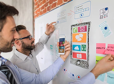 men brain storming the mobile app experience on a board