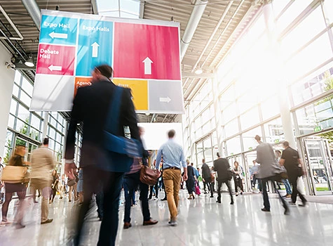 crowd of people walking in a conference center 