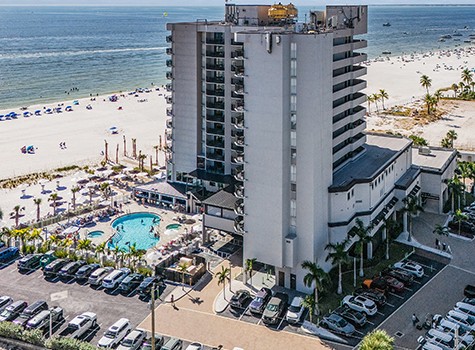 a building with cars parked on the beach