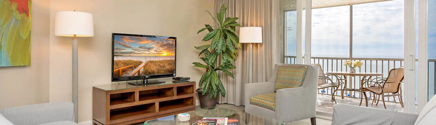 white couch and seating area with a brown TV cabinet 
