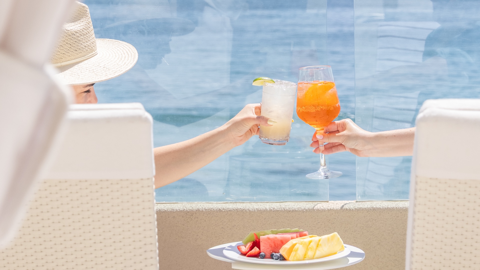 a pair of hands holding drinks