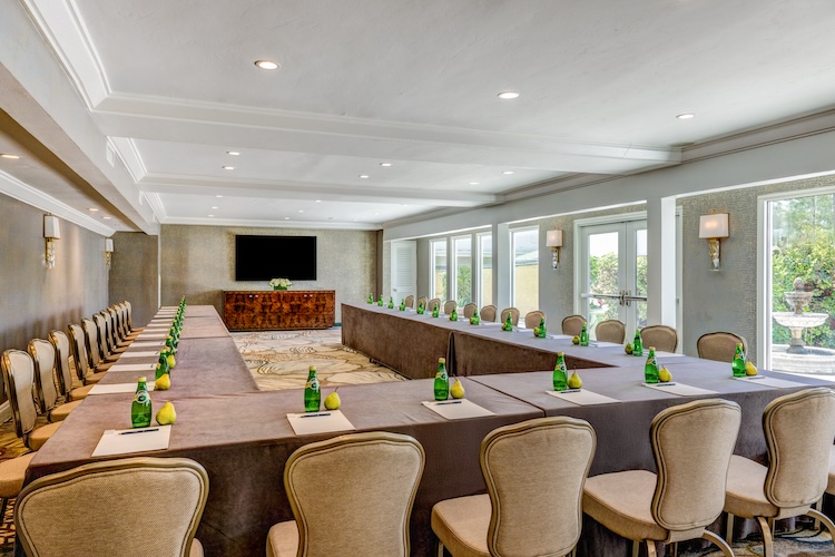 a room with long tables and chairs