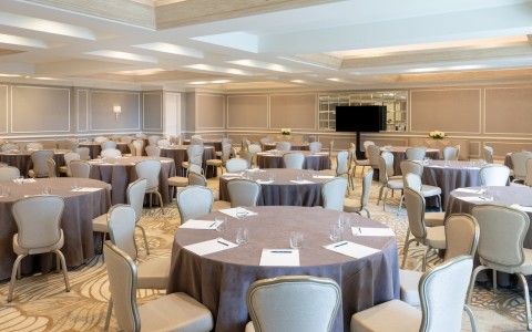 a room with round tables and chairs