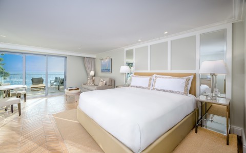 a bedroom with a large bed and a couch