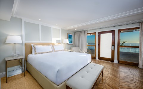 a bedroom with a large bed and a wood floor