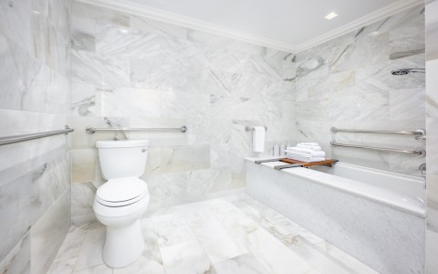 a bathroom with marble walls and a toilet