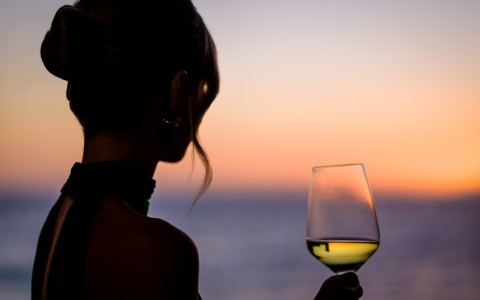 a woman holding a glass of wine