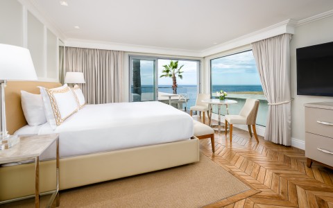 a room with a bed and a table and chairs and a table and chairs