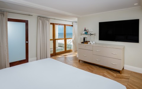 a bedroom with a television and a dresser