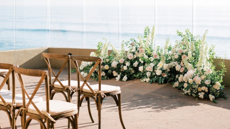 chairs and chairs with flowers in front of a window