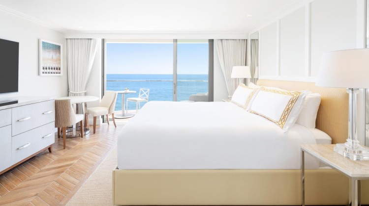 a room with a large bed and a table and chairs