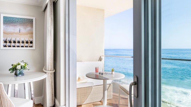 a glass door to a room with a table and chairs