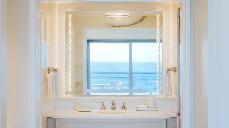 a bathroom with a view of the ocean