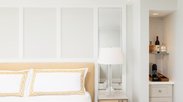 a bed with a lamp on a table