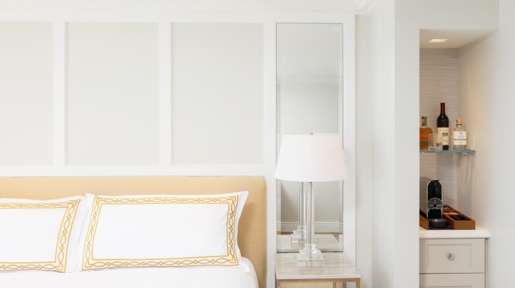 a bed with a lamp on a table