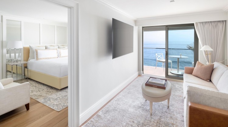 a room with a television and a view of the ocean