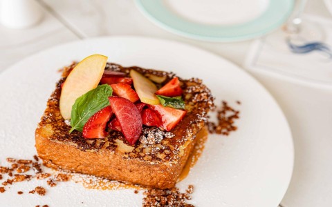 a plate of food with fruit on top