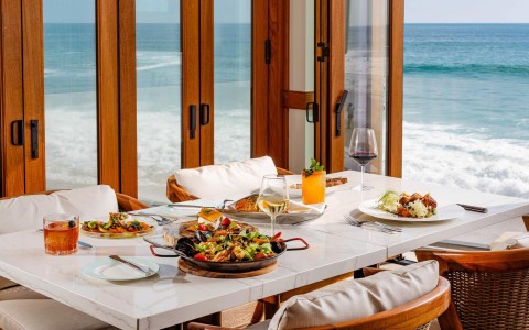 a table with food on it and a glass of wine on it