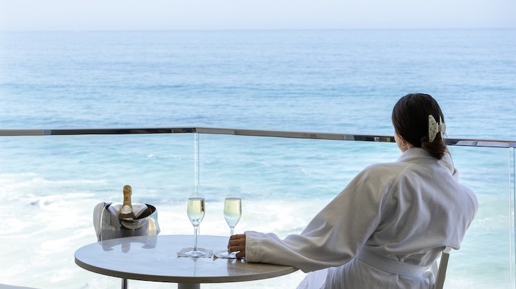 a woman sitting at a table with two glasses of champagne