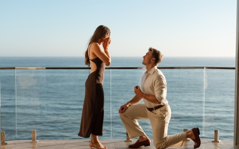 a man kneeling on one knee and woman standing on one knee