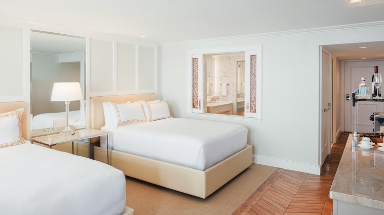 a room with two beds and a mirror