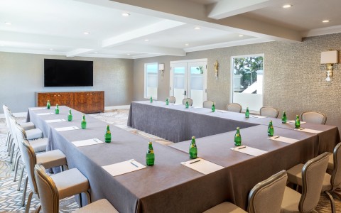a room with tables and chairs and a television