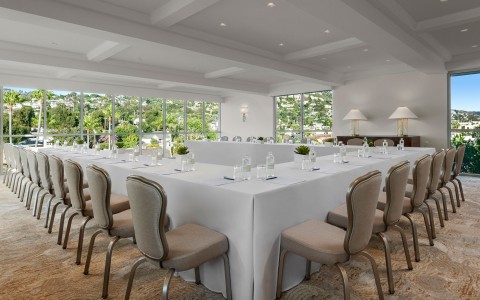 a room with a long table and chairs