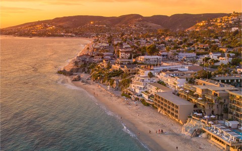 a beach with buildings and a body of water