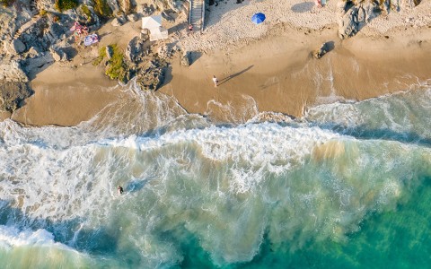 a beach with waves crashing on the shore