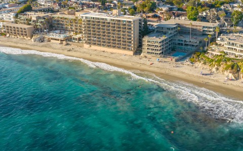 a beach with buildings and a body of water