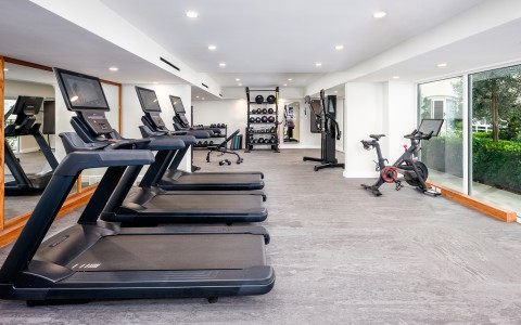 a room with treadmills and exercise bikes