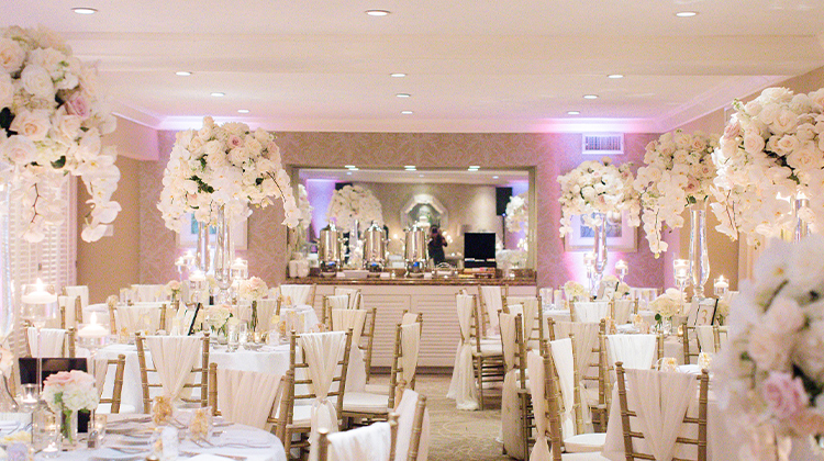 indoor venue filled with white decor and white roses
