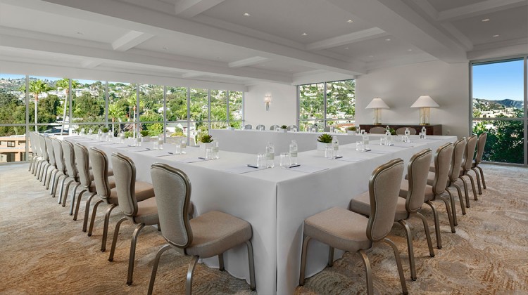 a room with a long table and chairs