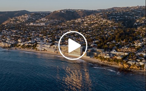 a beach with buildings and a body of water
