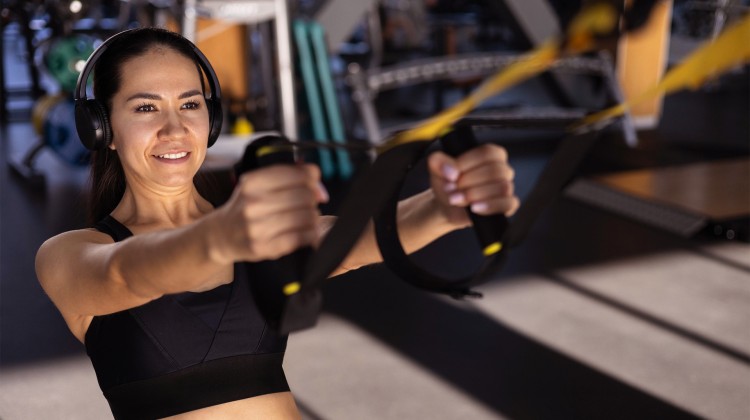 a woman working out with a trx strap
