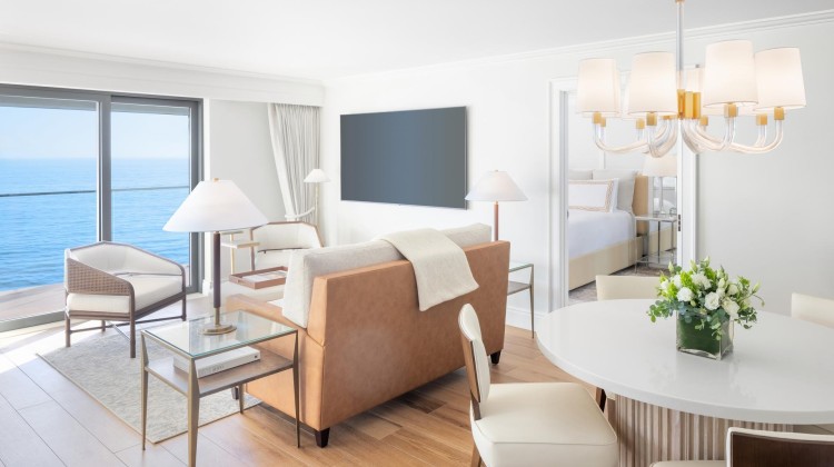 a room with a couch and a table and chairs