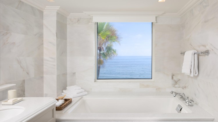 a bathroom with a large window and a bathtub