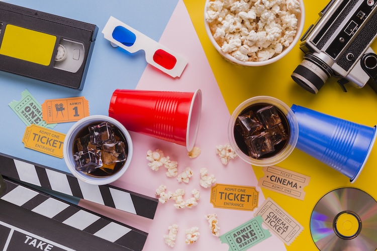 a movie camera and popcorn and glasses