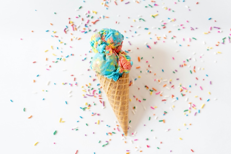 a cone with multicolored ice cream scoops on top