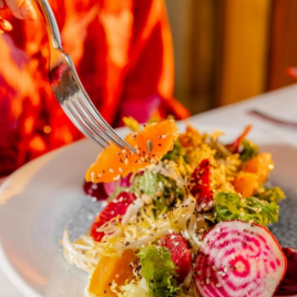 a fork on a plate of salad
