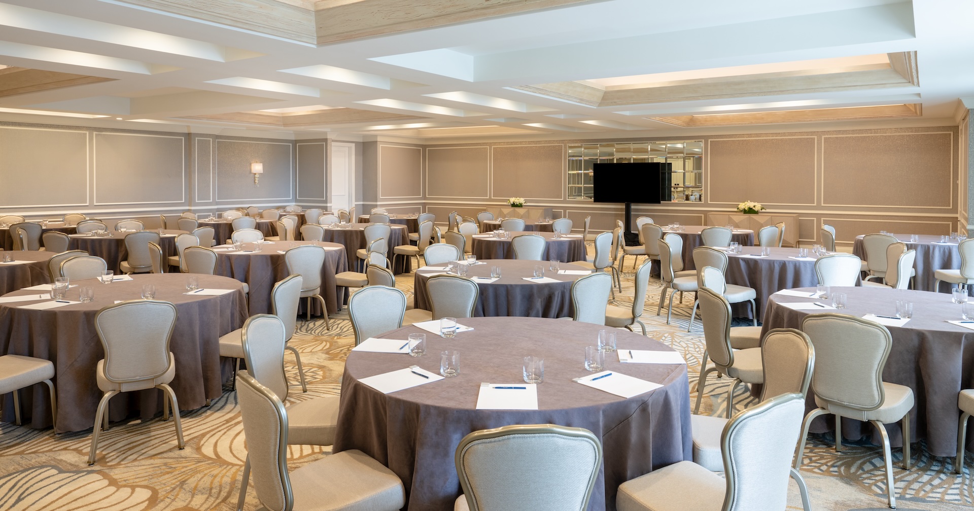 a room with round tables and chairs