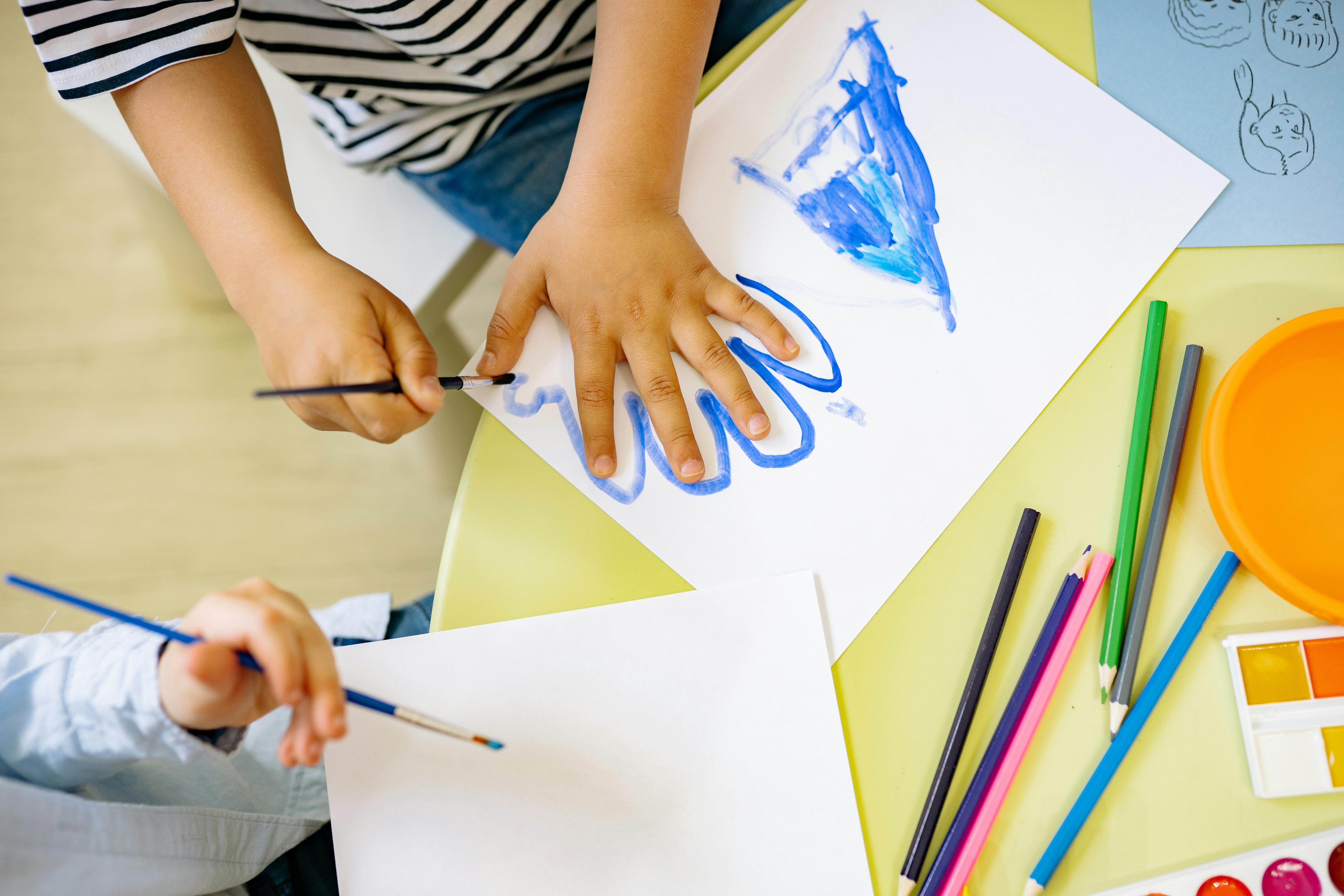 a child painting on a piece of paper