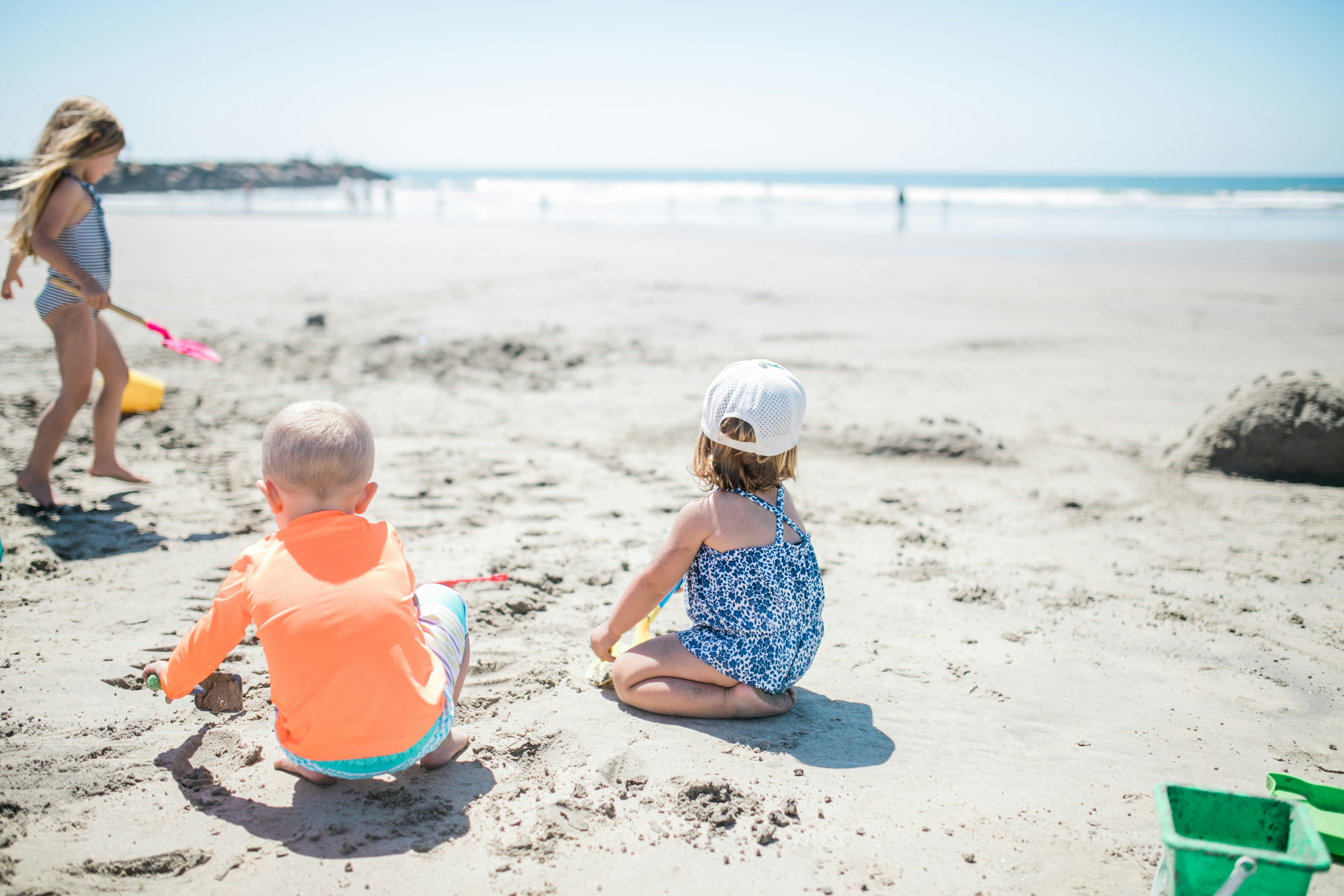 a two children sitting on the beach