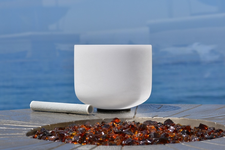 a white cup and cigarette on a table