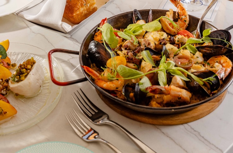 a pan of seafood and vegetables on a table