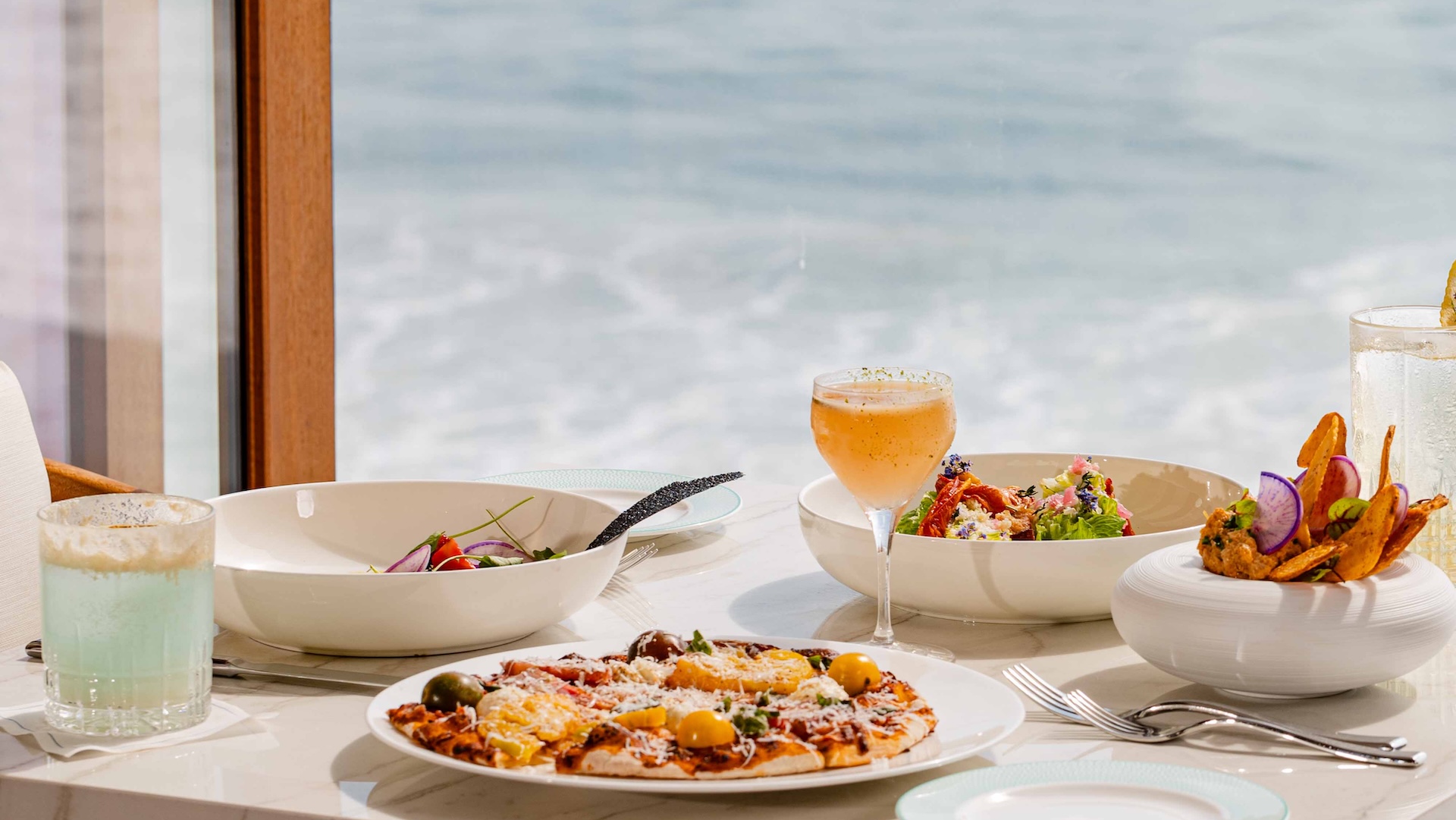 a table with plates of food and a drink