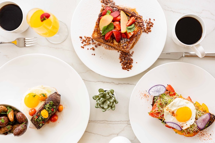 a table with plates of food and drinks