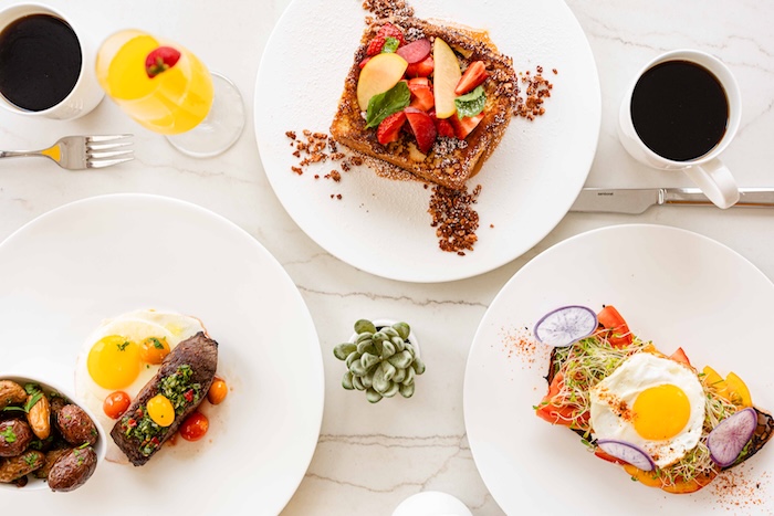 a table with plates of food and drinks